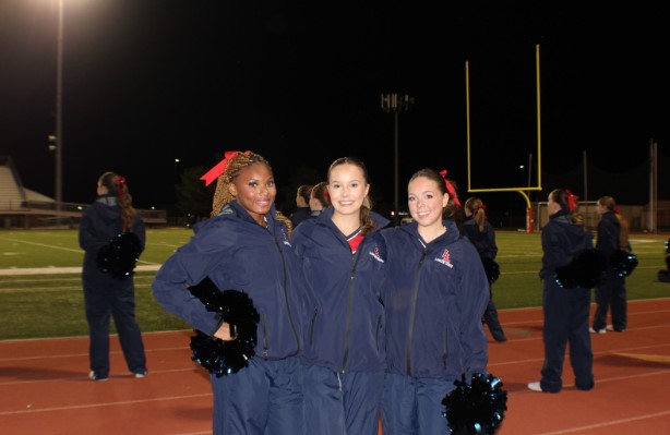 Cheer captains at the Sept. 18 football game. From left to right: Senior Bunny Rhodes, Sophomore Lily-Anne Lorenz, Senior Chloe Flesher. Photo by Harper Downey.