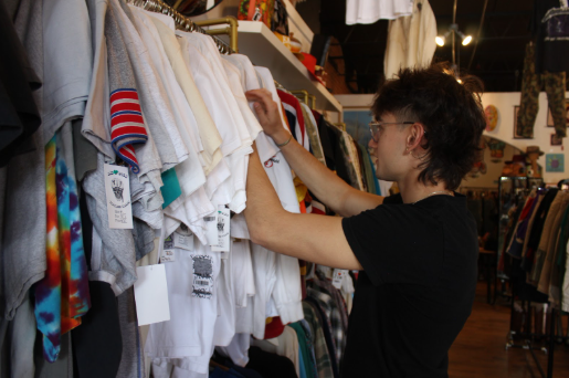 Student going through clothing at circa thrift. Sept 19. Photo by Morgan Dalton.