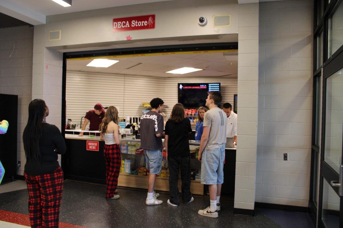 Students interacting and purchasing Deca products. Photo by Ayden Myers.