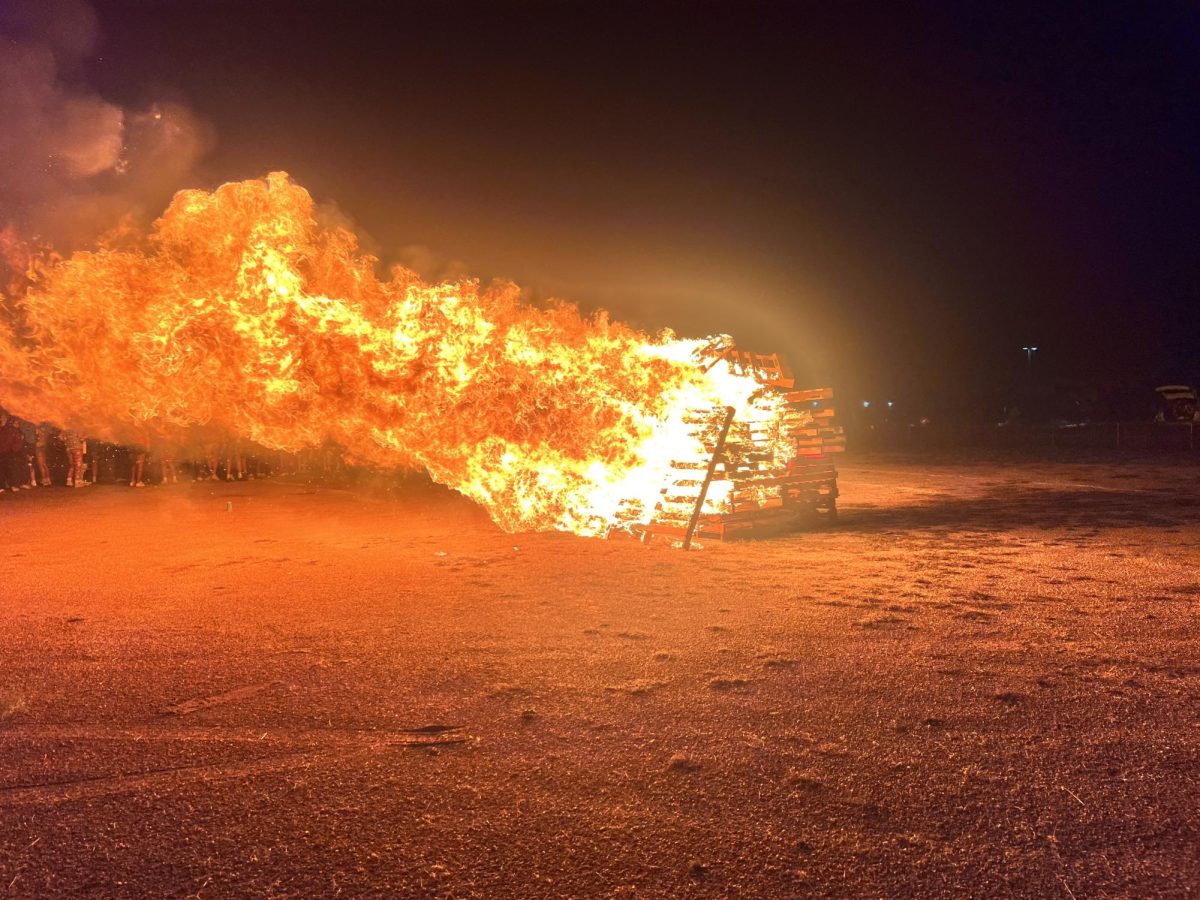 The 2024 post-Powderpuff bonfire on Sept. 9, 2024, in the Liberty dirt parking lot. Photo by Bella Howard.