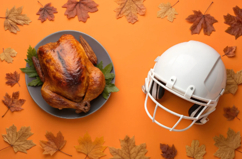 Football helmet next to a Thanksgiving turkey. Photo courtesy of Canva.com.
