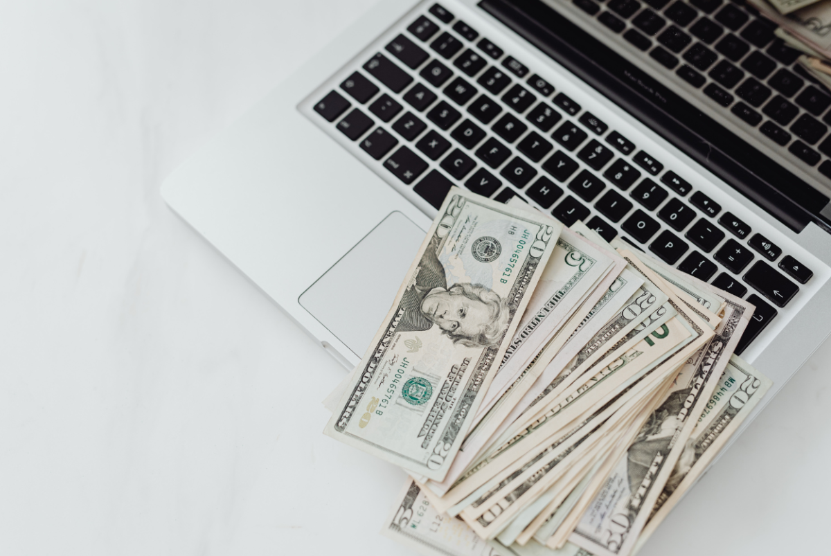 Cash laced on a computer. Photo from Canva.com. 