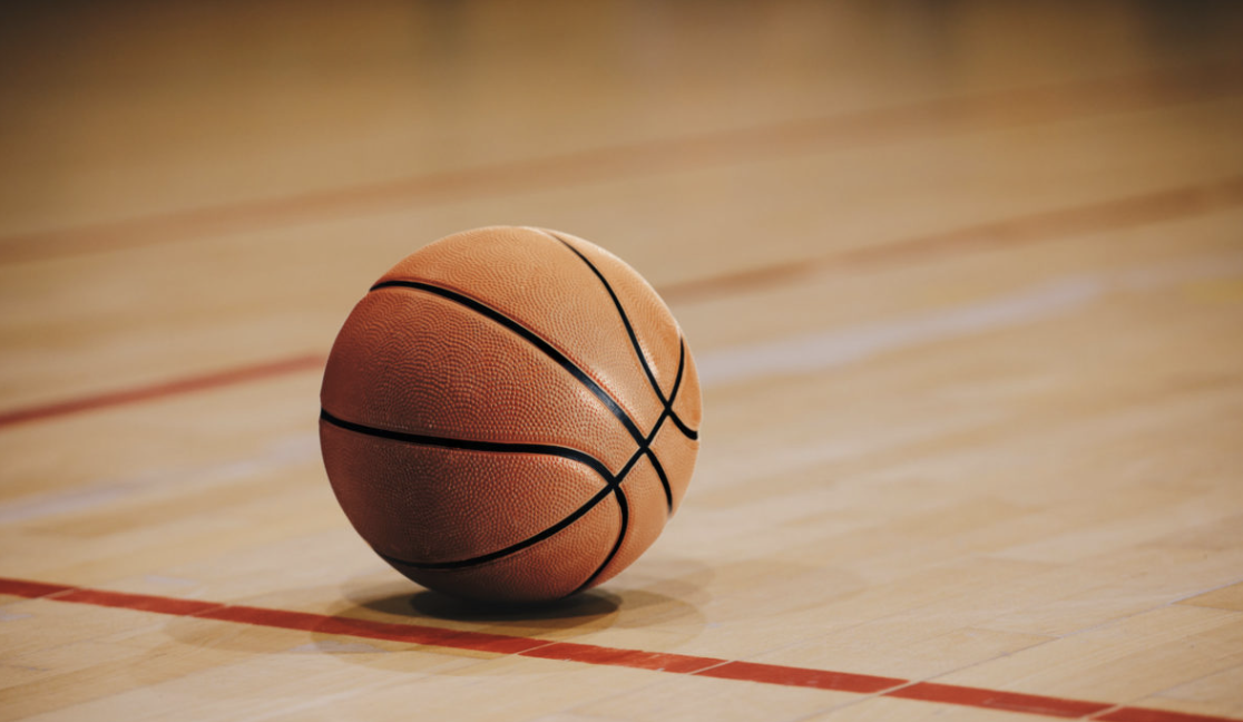 Basketball laying on a court. Photo from Canva.com.