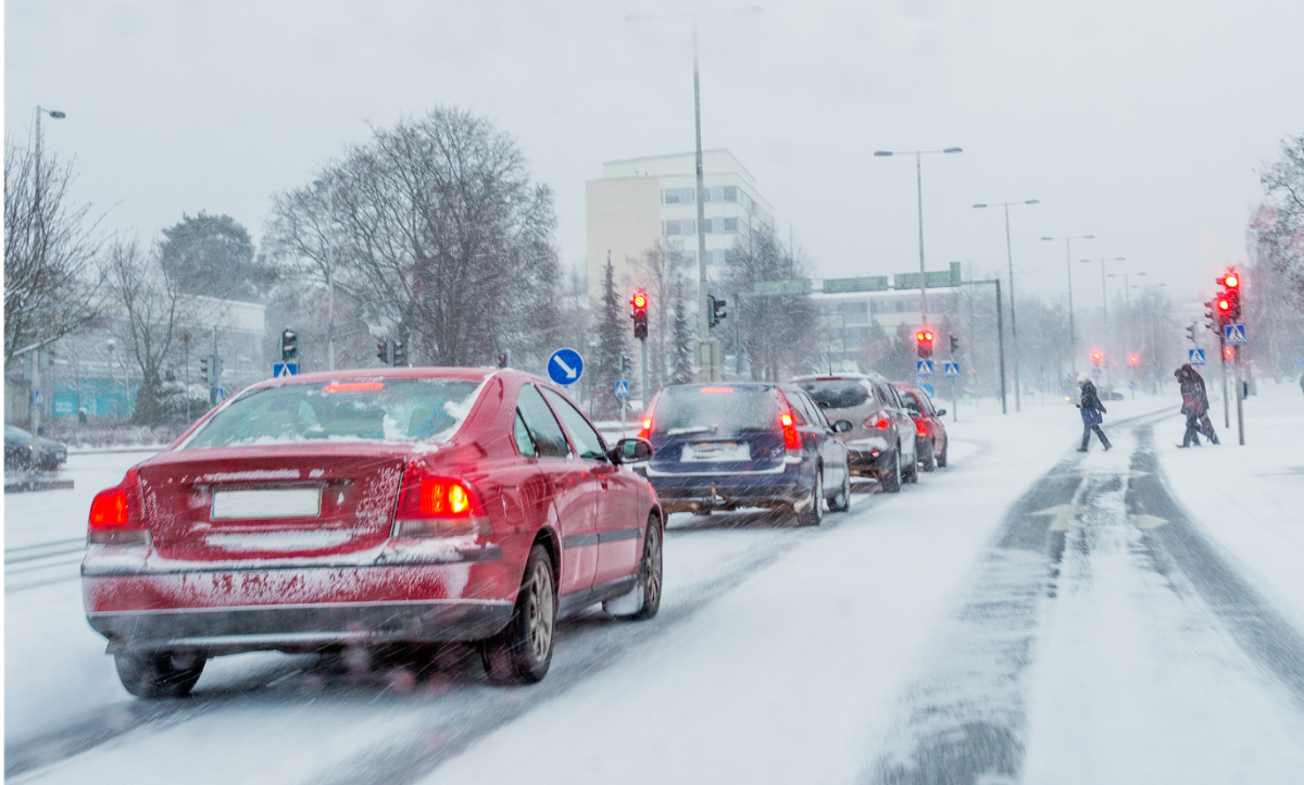 Cars driving in the snow at an intersection. Photo from Canva.com.