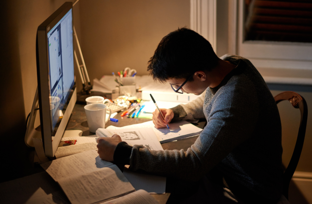 A student studying their schoolwork. Photo from Canva.com. 