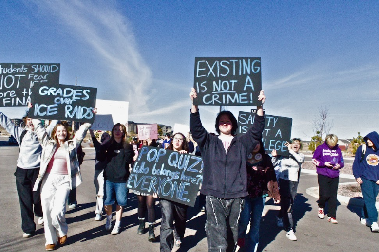 Liberty High School students holding ICE protest signs in the parking lot. Photo by Truly Daemke. 