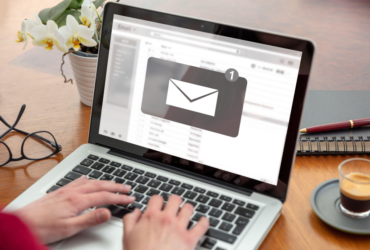 A person typing an email on a computer. Photo from Canva.com.