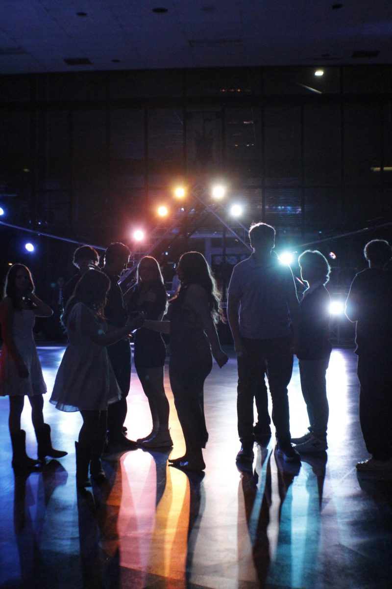 Students under the lights of the winter dance floor. Photo by Isabella Howard. 