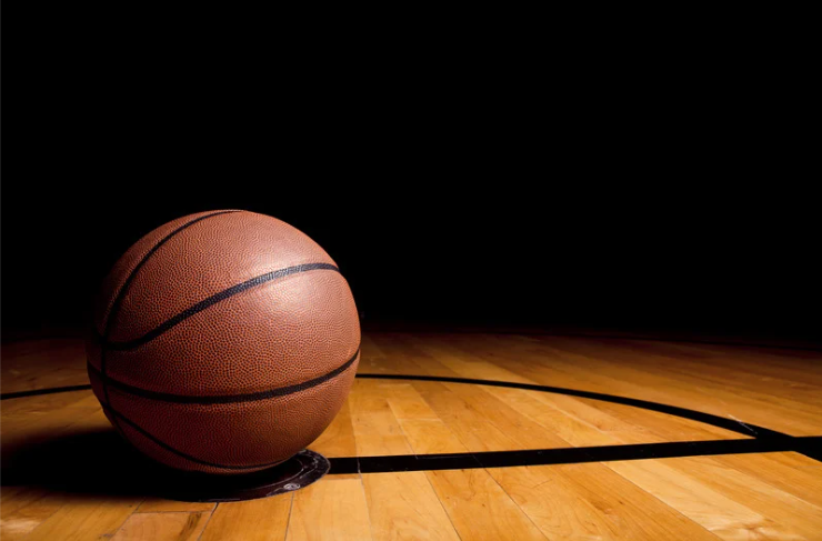Photo of a basketball laying on a court. Photo courtesy of Canva.com.