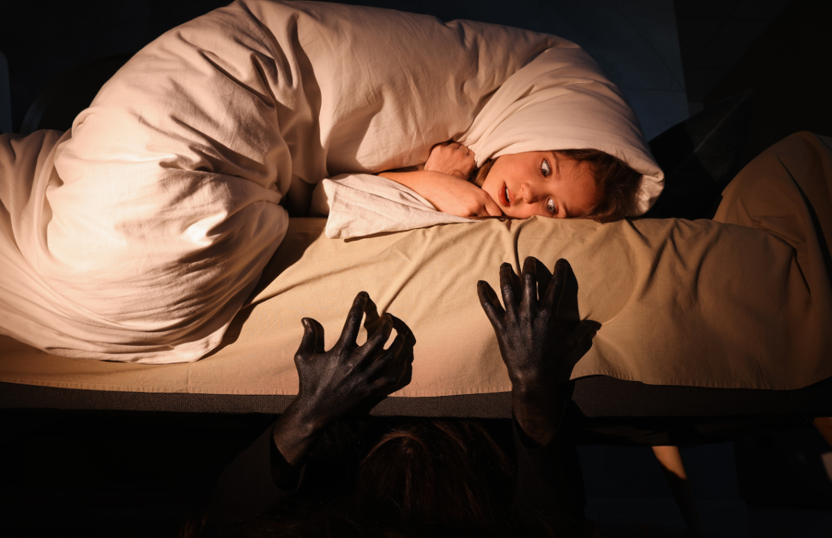 A monster reaching out from under a bed. Photo from Canva.com. 