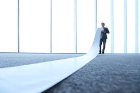 A man holding a very long list. Photo by iStock.