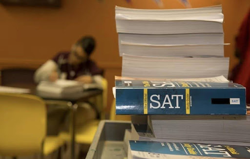 Focus on SAT exam guides; while test-taker studies. Photo by Unsplash.com.